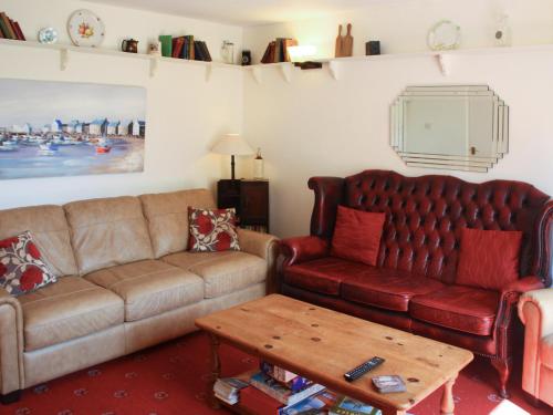 a living room with a couch and a coffee table at Churchview House in Winterborne Abbas