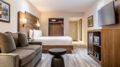 a hotel room with a bed and a couch at Atrium Hotel Vancouver in Vancouver