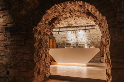 an archway in a stone building with a sink in a room at DOMA u nás Boutique hotel & spa in Poprad