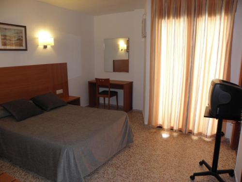 Ένα ή περισσότερα κρεβάτια σε δωμάτιο στο Hotel Jardín