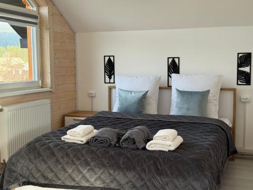 a bedroom with a large bed with towels on it at Іній in Vorokhta