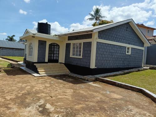 a house that is sitting in a yard at Greenstar villa homes in Kisii