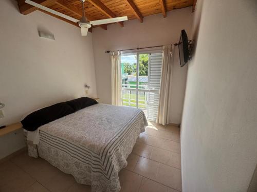 En eller flere senge i et værelse på Complejo Hueney Departamentos