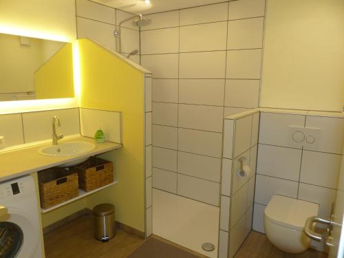 a small bathroom with a toilet and a sink at Ferienwohnung Paula in Lichtenstein