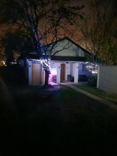 a house with christmas lights on it at night at Marina Cottage in Enying