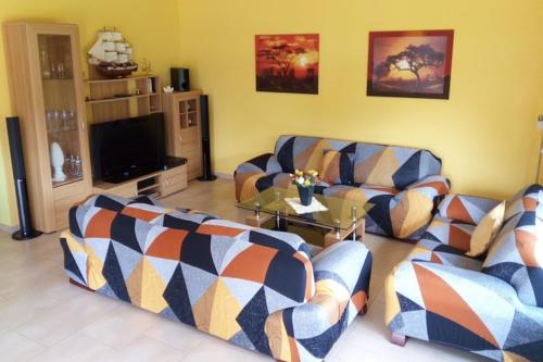 a living room with two couches and a television at Apartment house at Kiessee, Westerholt in Westerholt