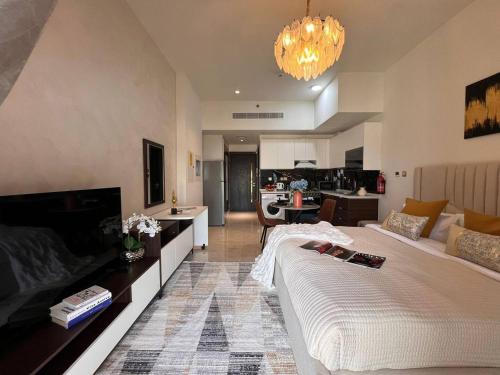 a living room with a large bed and a couch at Fully Equipped Home near Miracle & Butterfly Gardens in Dubai
