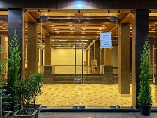 a glass door of a building with a sign on it at Hanuman Heritage in Chikmagalūr