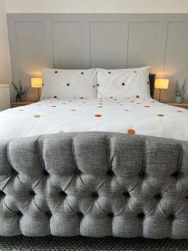 a bedroom with a large bed with white sheets and pillows at Delightful 1 Bedroom Cottage in Buxton