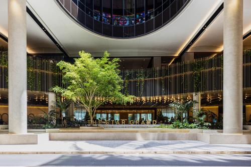a building with a tree in front of it at Luxury 50th Floor 2BR at Queens Wharf with Parking in Brisbane