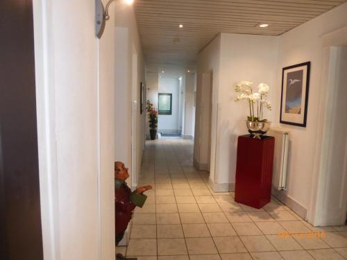 a teddy bear is standing in a hallway at Astoria Hotel in Ratingen