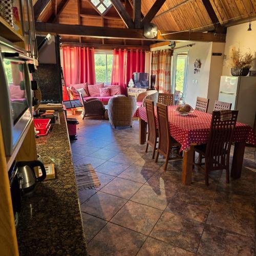 a living room with a table and chairs and a couch at Bienvenue chez Gaston in Le Tampon