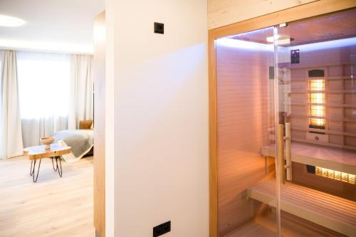 a room with a shower with a glass door at NĀVA PLACE Cozy home in Kaprun in Kaprun