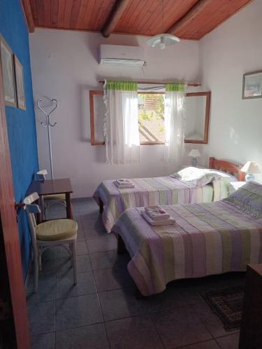 a bedroom with two beds and a table and a window at UNSER TRAUM in Concordia