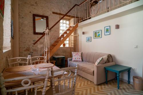a living room with a couch and a table at Rastoni 1928 in Aegina Town