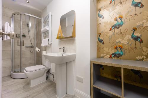 a bathroom with a shower and a toilet and a sink at Harbour Hub Hotel in Southampton