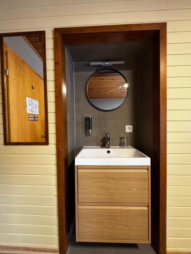 a bathroom with a sink and a mirror at Familiehotel La Randulina in Ramosch