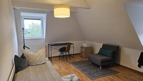 a living room with a couch and a chair at stilvolles Apartment für 4 Personen in Ulmerfeld in Ulmerfeld