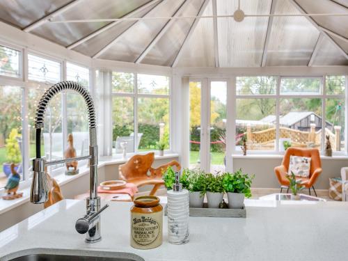 een keuken met een wastafel en een bos ramen bij Featherstone House in Heighington