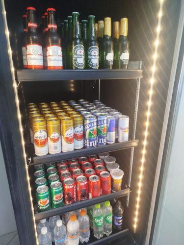 a refrigerator filled with lots of different types of drinks at Hotel Portal do Sertao in Feira de Santana