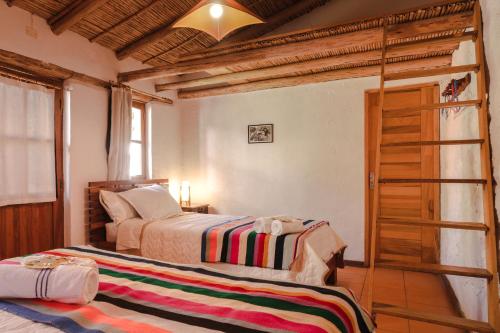 a bedroom with two beds and a ladder at La Selenita in Sucre