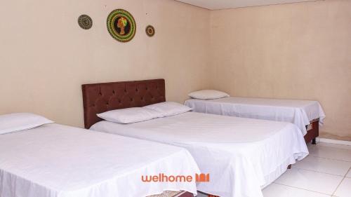 En eller flere senge i et værelse på Suite em Pousada em Rio Grande com Vista e Lago