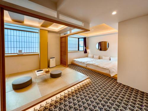 a bedroom with a large bed and two windows at Hotel Imagine Kyoto in Kyoto