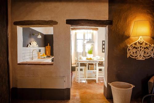 a kitchen and living room with a table and a window at Podere Cavalbianco in Monte San Savino