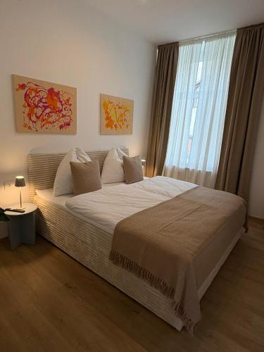 a bedroom with a large bed with a large window at Modern apartment in Ferlach in Ferlach