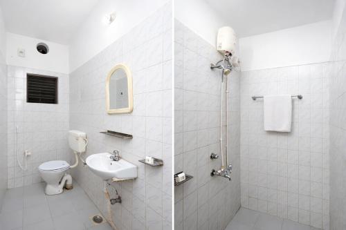a white bathroom with a toilet and a sink at Hotel #Blue Moon# Front Of Bhubaneswar Railway Station in Bhubaneshwar