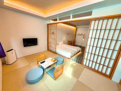 a room with a bedroom with a bed and a table at Hotel Imagine Kyoto in Kyoto
