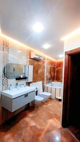 a bathroom with two toilets and a sink and a mirror at 3 bedroom Nijma large authentic Moroccan apartment in Tangier