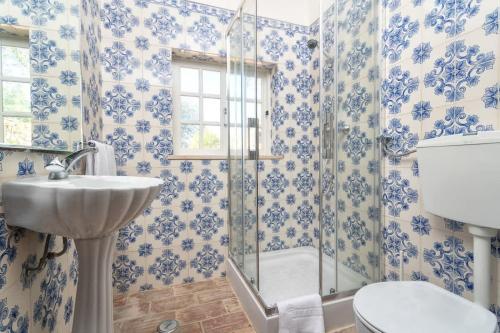 a bathroom with a shower and a sink and a toilet at Spacious Villa Swimming Pool by HostWise in Lagoa