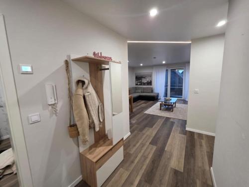 a hallway with a living room and a room with at NEU! Modernes Wohnen Bad Berleburg in Meckhausen