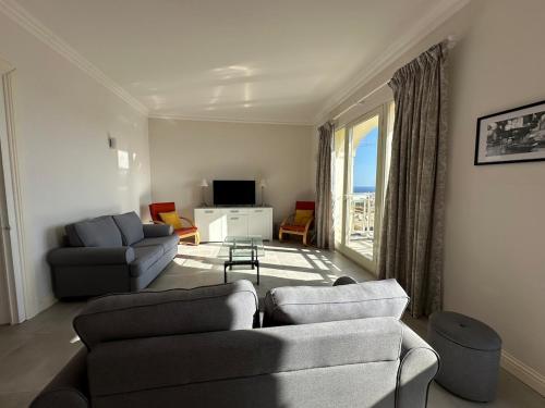 a living room with two couches and a television at Valletta Minimal, Breezy, Coastal chic City Life in Valletta
