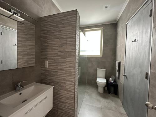 a bathroom with a sink and a toilet at Valletta Minimal, Breezy, Coastal chic City Life in Valletta