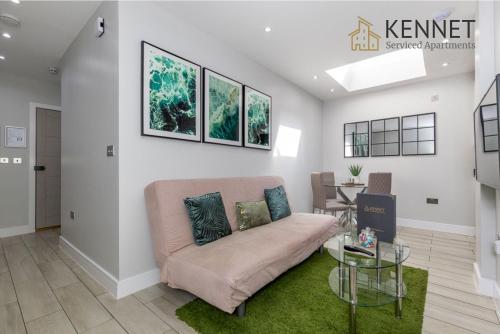 a living room with a couch and a table at Elm House in Reading