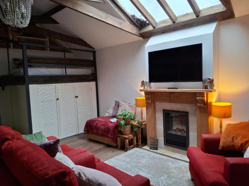 a living room with a fireplace and a flat screen tv at The LITTLE HOUSE in HULL in Hull