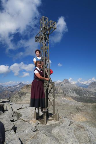 a woman and child standing next to a cross on a mountain at Rooms Alpe Veglia-Varzo in Varzo