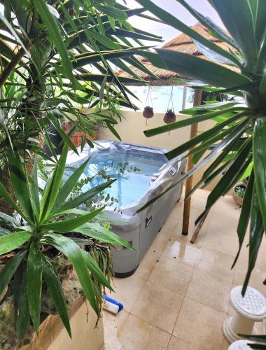 a large bath tub in a room with plants at Villa Secret Spot Luxury in Lourinhã