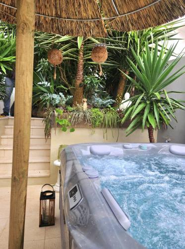 a hot tub in a resort with plants at Villa Secret Spot Luxury in Lourinhã