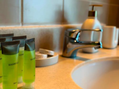 a counter with two bottles of soap and a sink at Khayali Marina Holiday Homes Dubai Marina JBR in Dubai