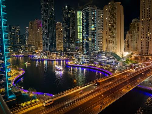 a view of a city at night with a freeway at Khayali Marina Holiday Homes Dubai Marina JBR in Dubai