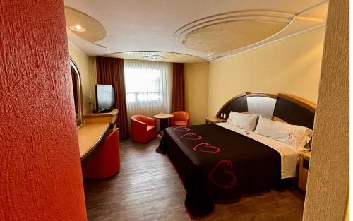 a hotel room with a bed and a television at Hot Plaza Camarones - Love Hotel - Solo Adultos in Mexico City
