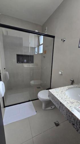a bathroom with a shower and a toilet and a sink at FLATS MELO unimontes in Montes Claros
