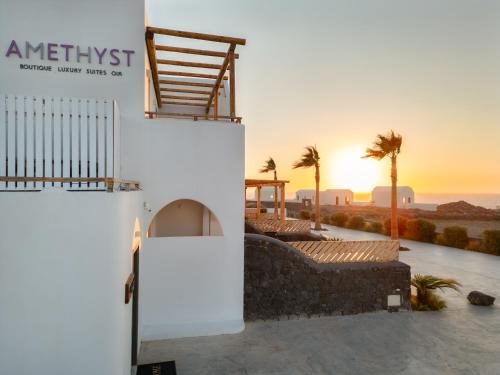 a view of the sunset from the outside of a building at The Amethyst Exclusive Suites Oia in Oia