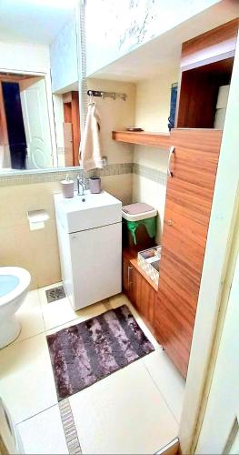 a small bathroom with a toilet and a sink at Apartment Cabin-Style in Belgrade