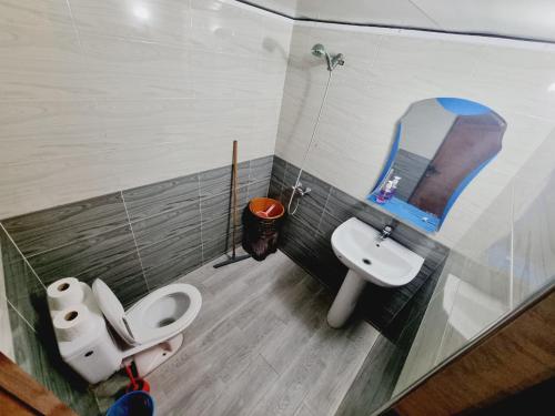 a bathroom with a sink and a toilet and a mirror at MJ twin blue door imsouane in Imsouane