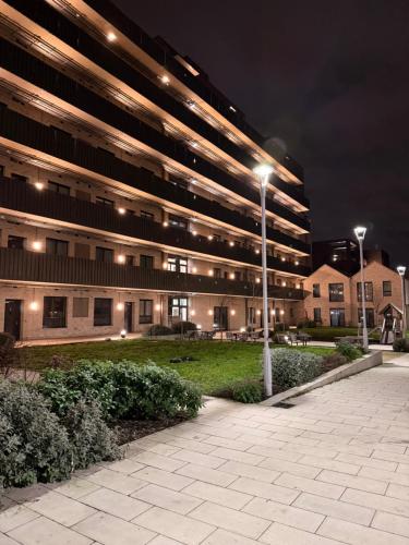 a large building with street lights in front of it at HRF Barking Apartments in Barking