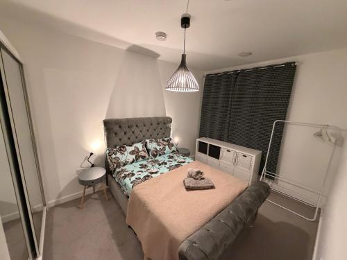 a bedroom with a bed and a couch in it at HRF Barking Apartments in Barking